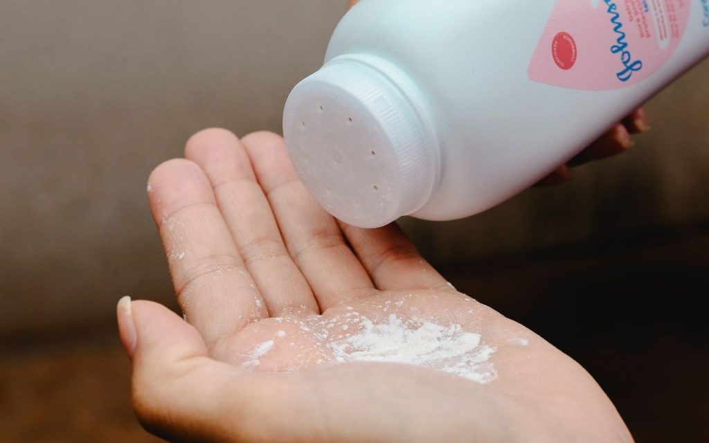 Johnson & Johnson talcum powder being poured into a hand